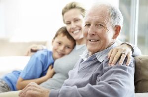Closeup portrait of a senior man sitting with his daughter and grandson