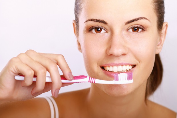 Woman with great teeth holding tooth-brush