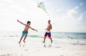 Father and son playing with kite